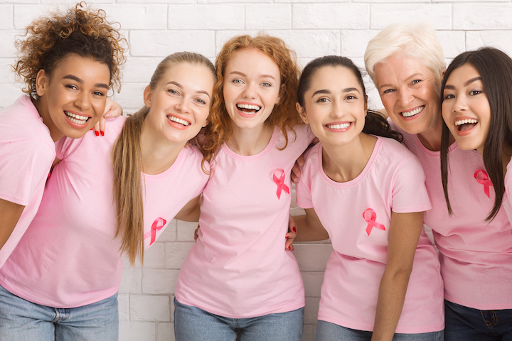 Women With Pink Breast Cancer Ribbons Laughing