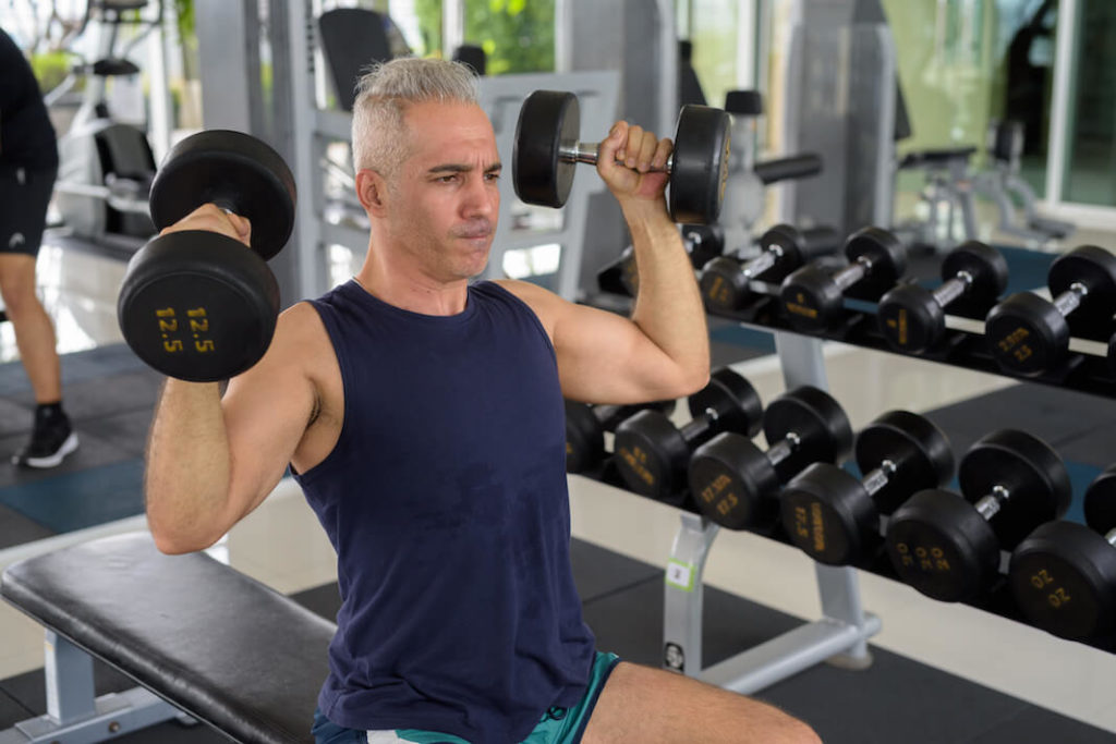 men's sports over 40 - lightweight resistance training exercise at gym