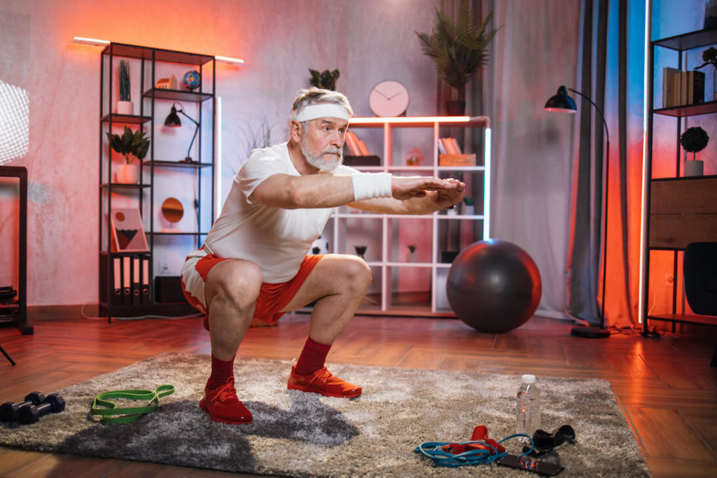 Senior Man Doing Proper Squat Workout at Home Without Hurting Knees