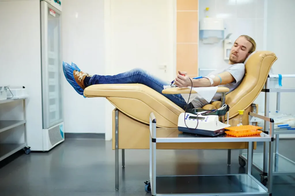 Blood Donation Side Effects and Risks - Relaxed man donating blood not worried about risks or side effects
