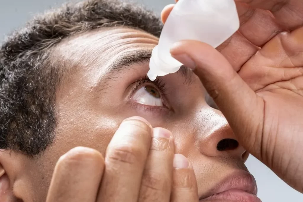 Eyes Watering Treatment - Man Putting Allergy Medication Eye Drops