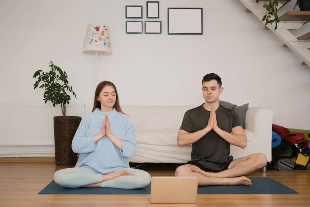 Solutions to Infertility - Relaxed Couple Performing Infertility Yoga Training