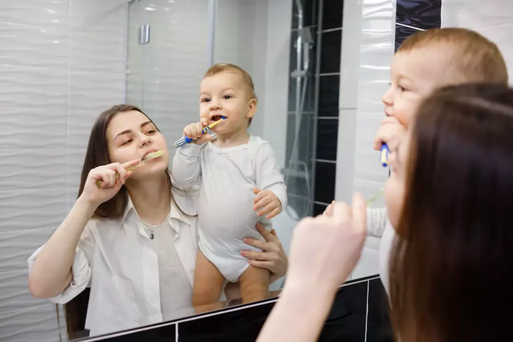 How to Take Care of Baby's Teeth Health and Prevent Teeth Decay - Baby is brushing his teeth with mom