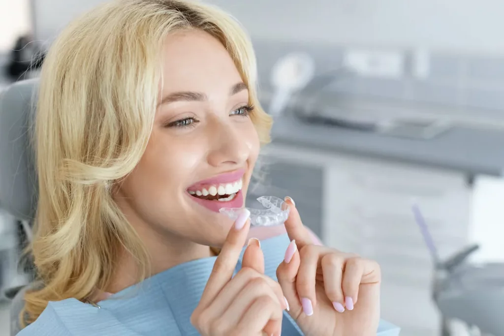 Which Is the Best Way To Take Care of My Retainer - Happy woman wearing her invisible clear teeth retainer