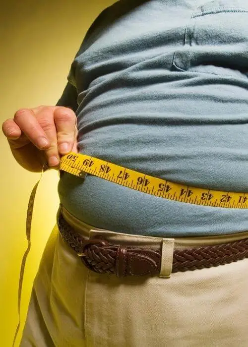 Free Body Fat Calculator - Fit male measuring his body fat